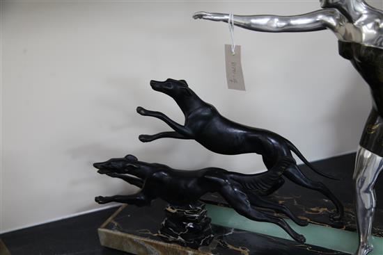 Uriano. A French Art Deco patinated bronzed spelter group of a lady and two running hounds, width 28in.